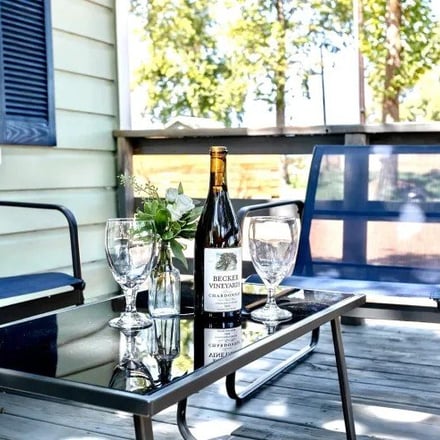 Deck with Becker Vineyards wine and chairs at The Sanctuary